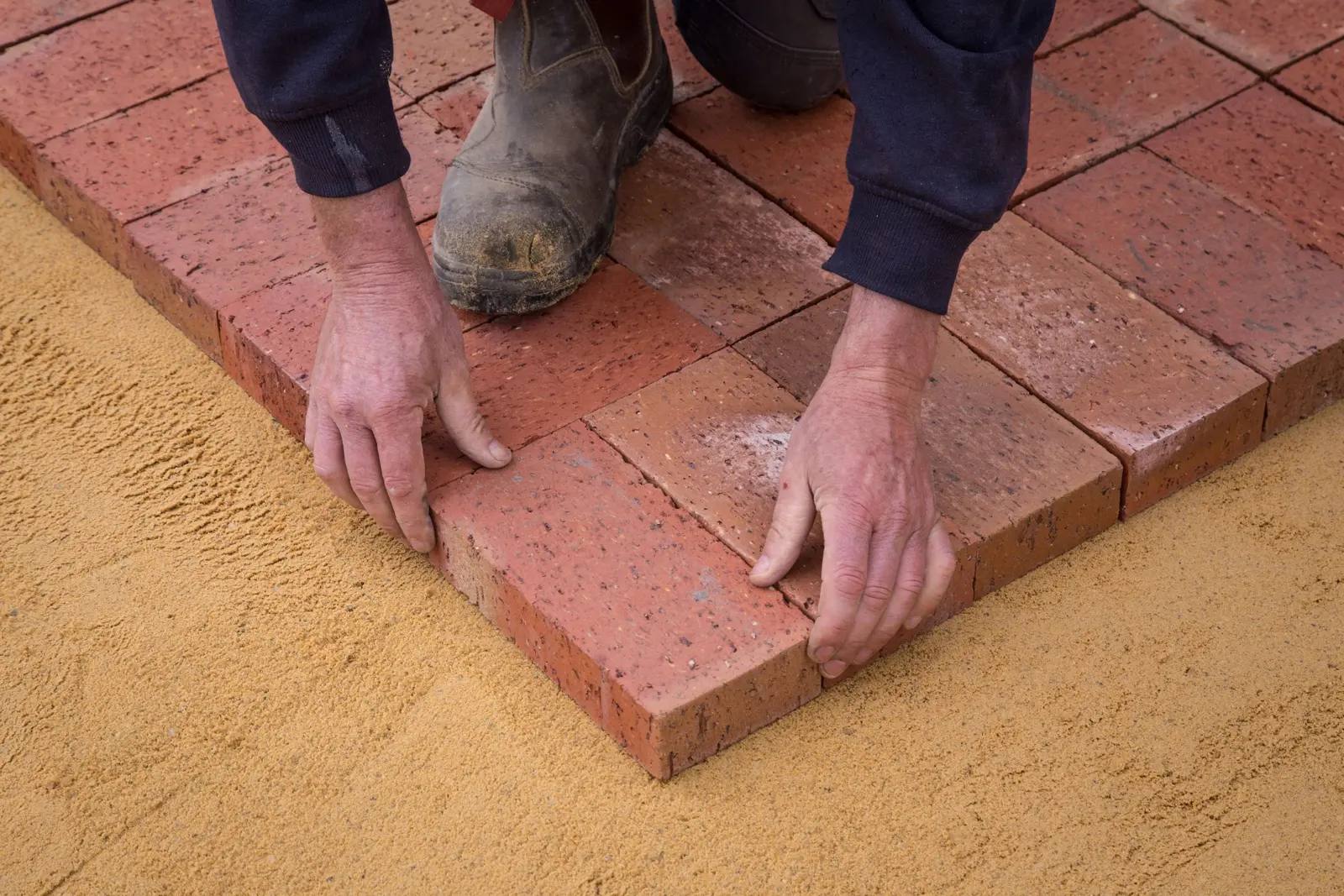Block paving being laid on a sand bed