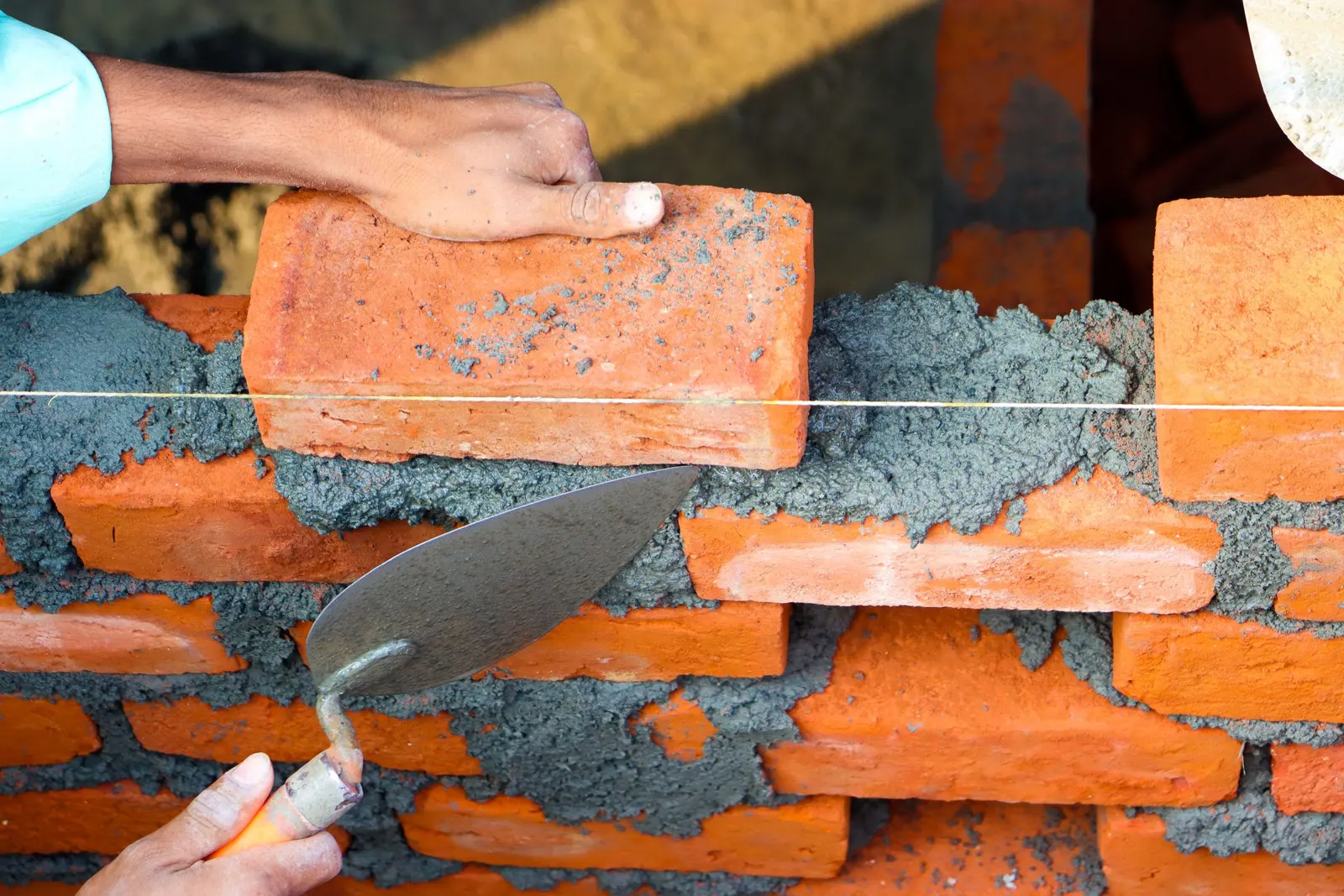 Bricks being laid on mortar