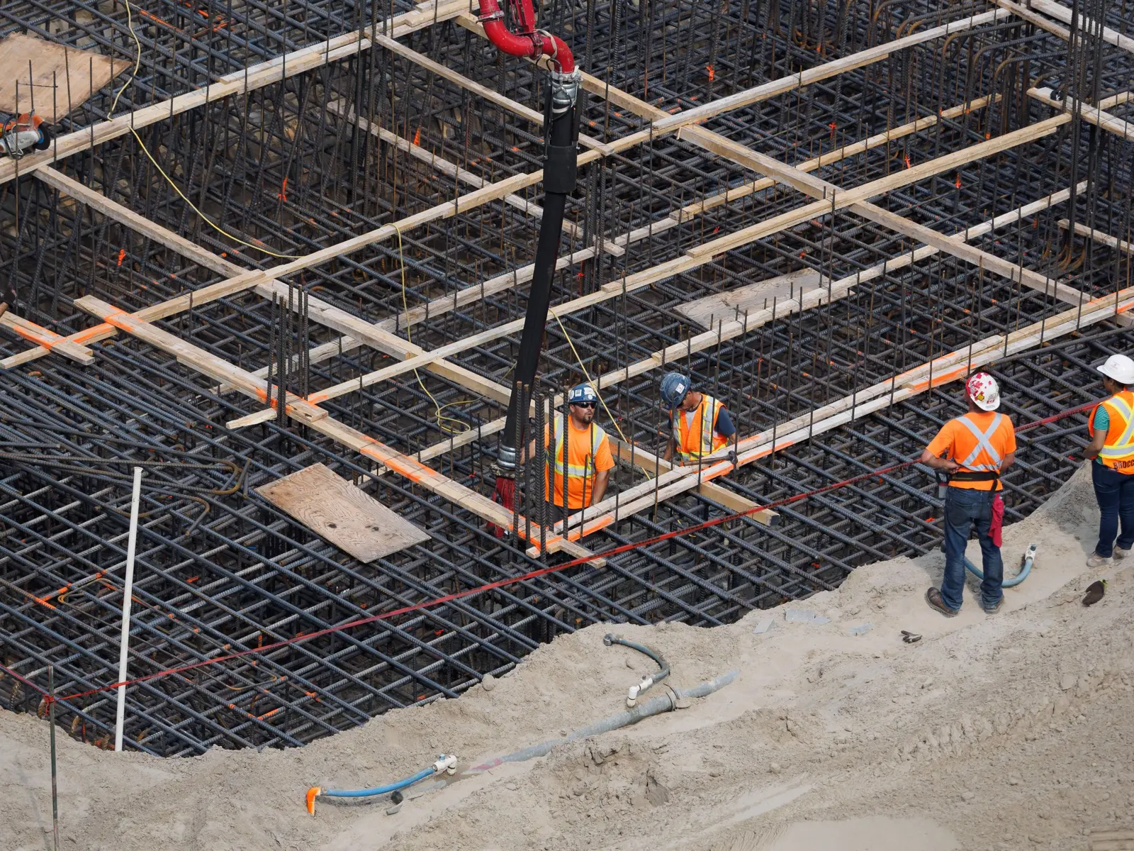 Groundworkers preparing reinforcement for a foundation pour