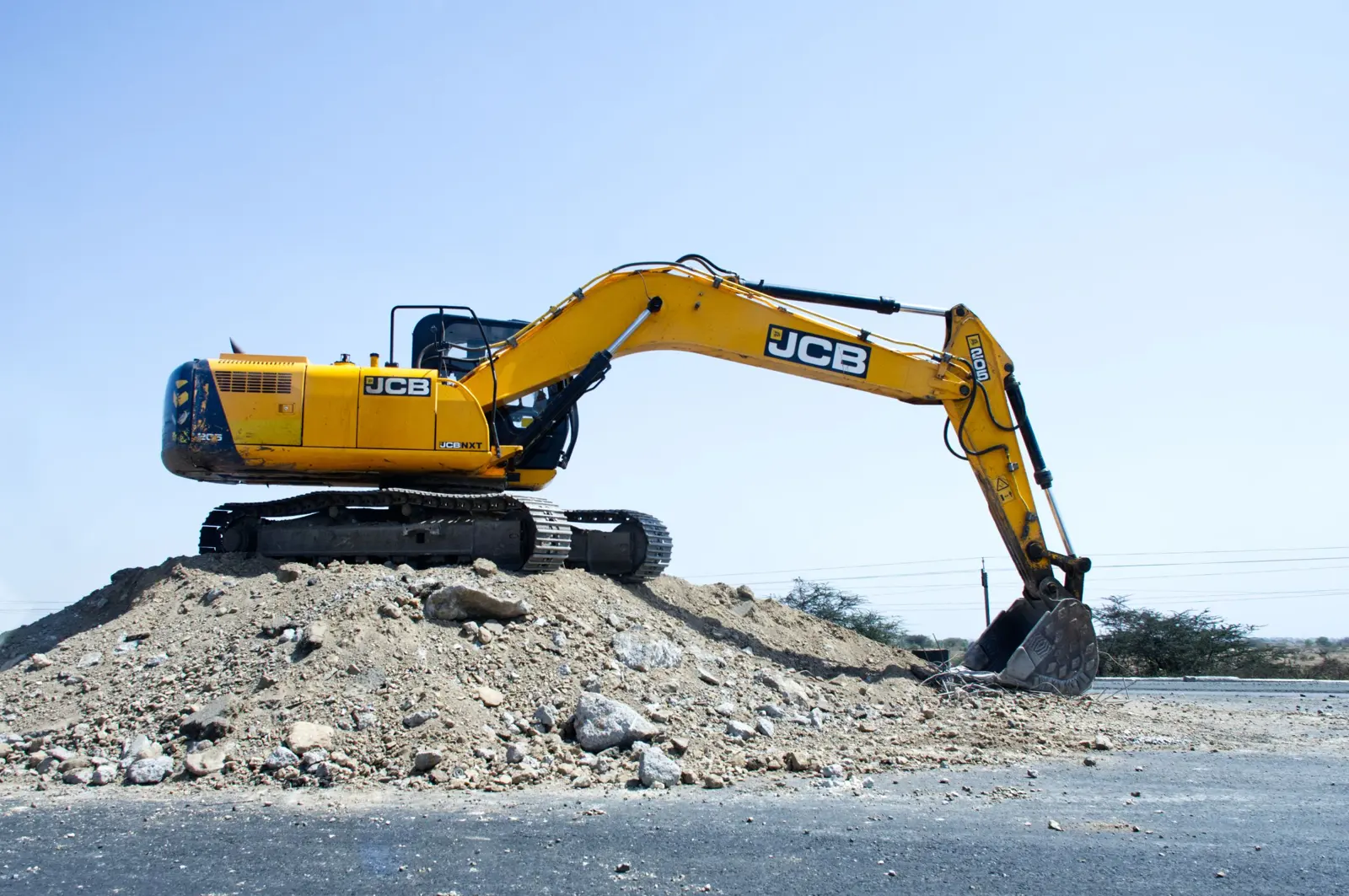 JCB tracked excavator working on a spoil heap